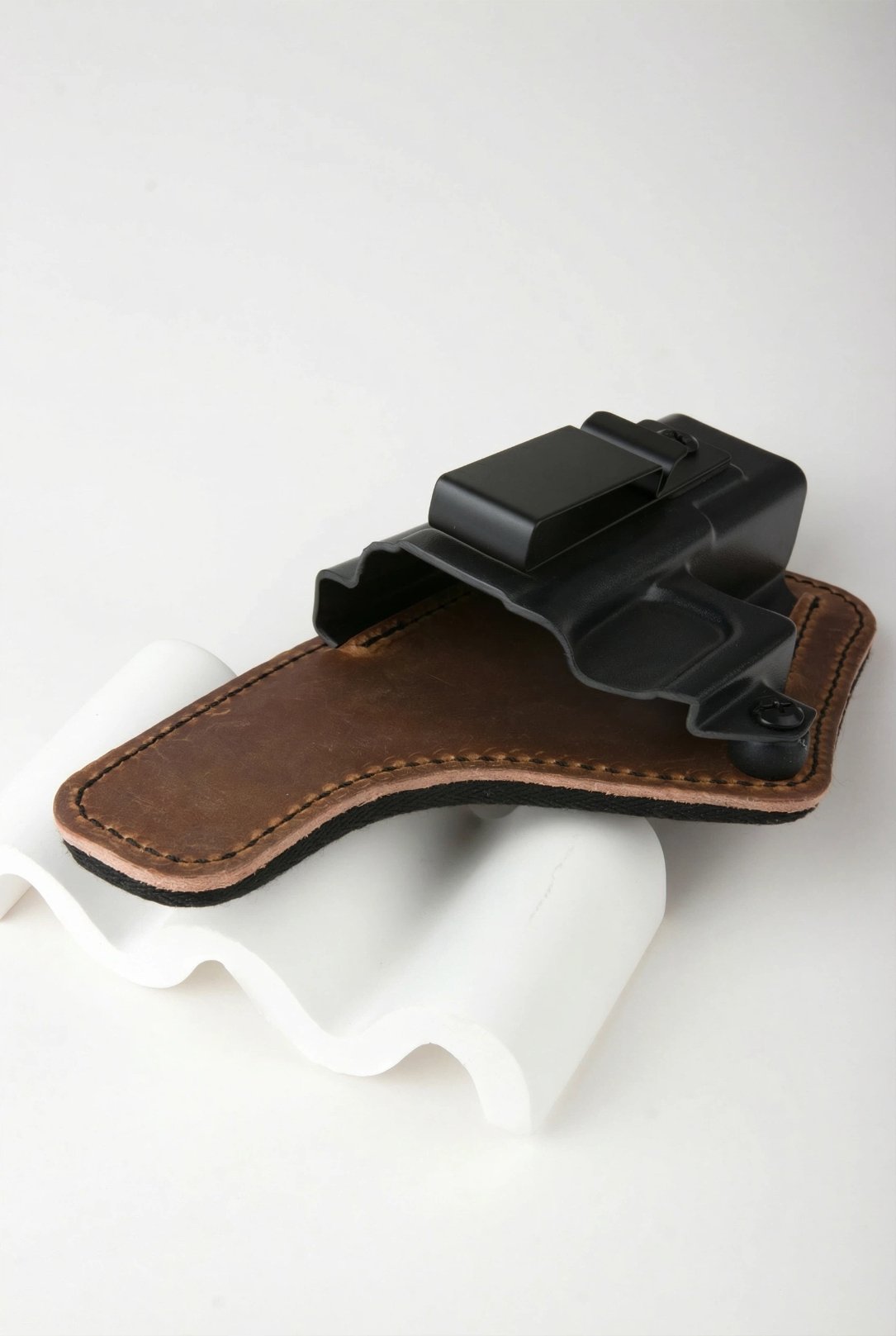 Hybrid IWB holster with thermoplastic shell and leather backing