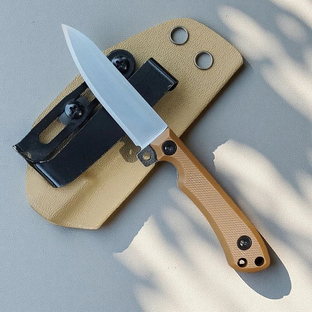 EDC fixed blade knife with compact thermoplastic sheath laid flat for size reference